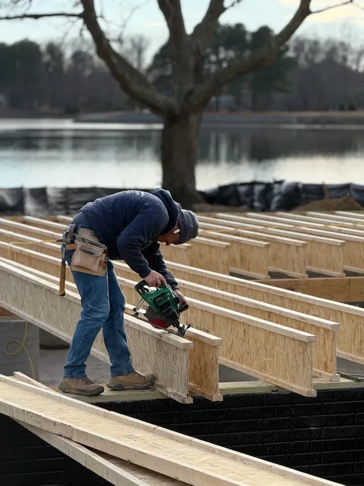 Matt Self, owner of Legasea Construction, cutting floor joists on a waterfront job site