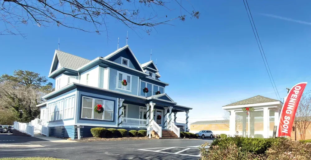 The Legasea office, a blue Victorian with a white wraparound porch on Main Street in Kilmarnock