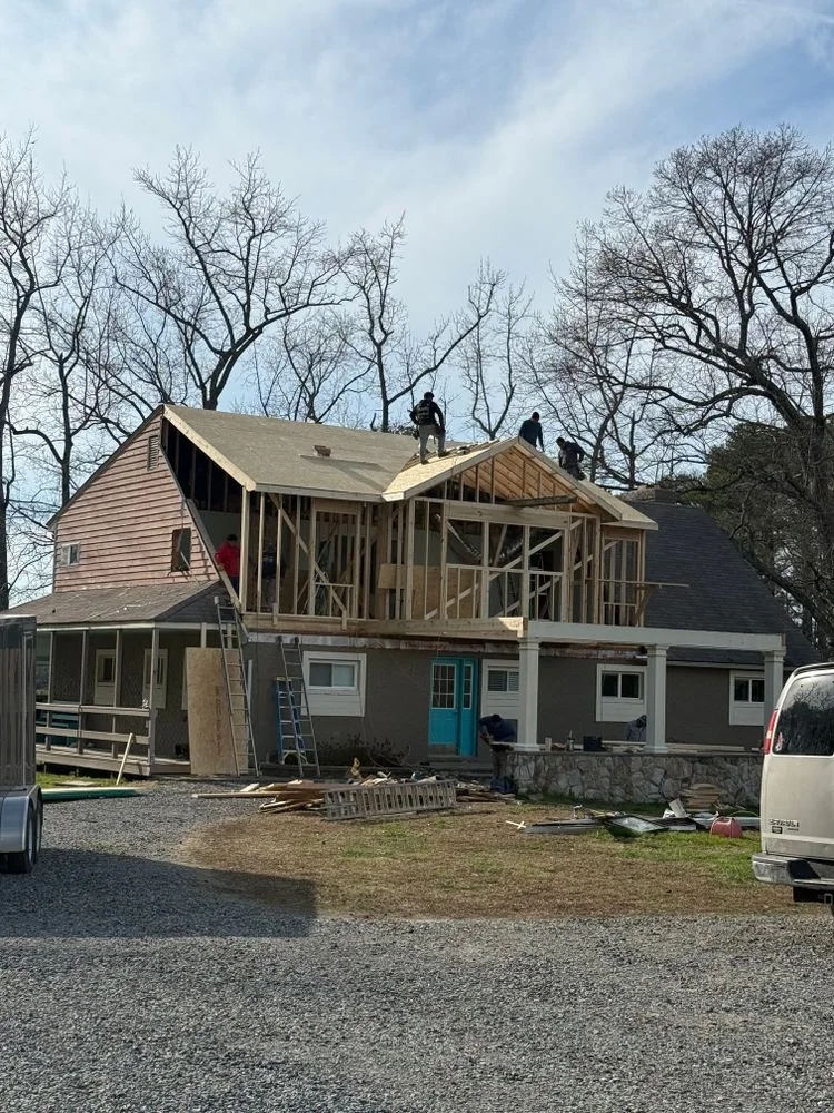 A second-story addition being framed on an existing home